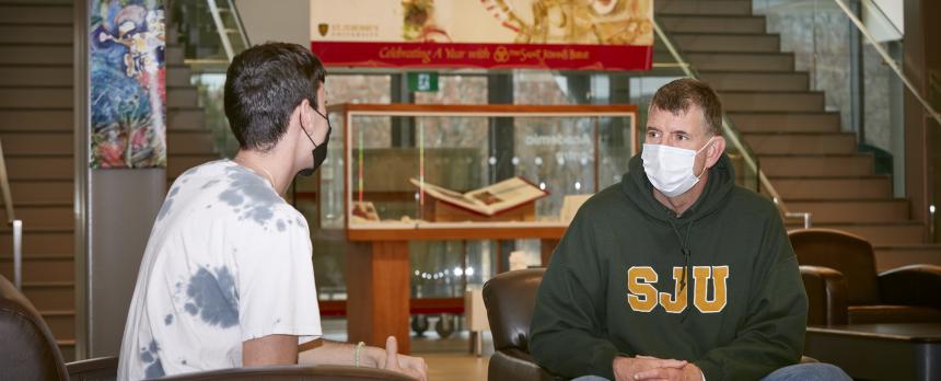 Sean Hayes speaking with student in SJU Academic Centre Atrium